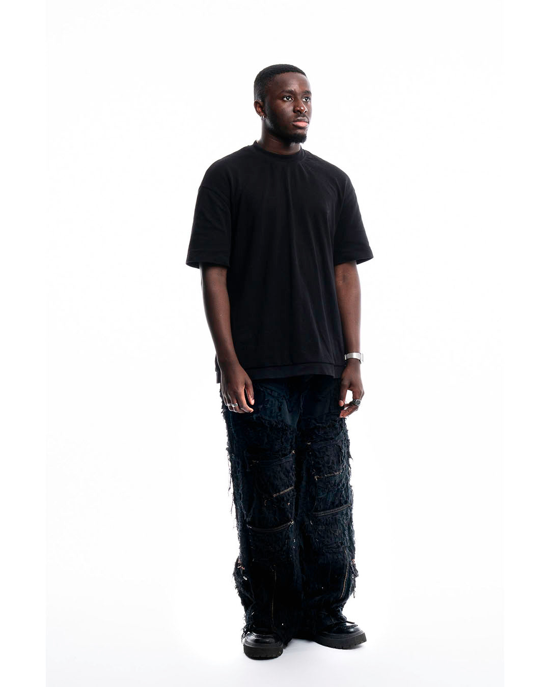 Side view of Obsidian Shred Denim Jeans by Prototypesparis, bold and modern fit.